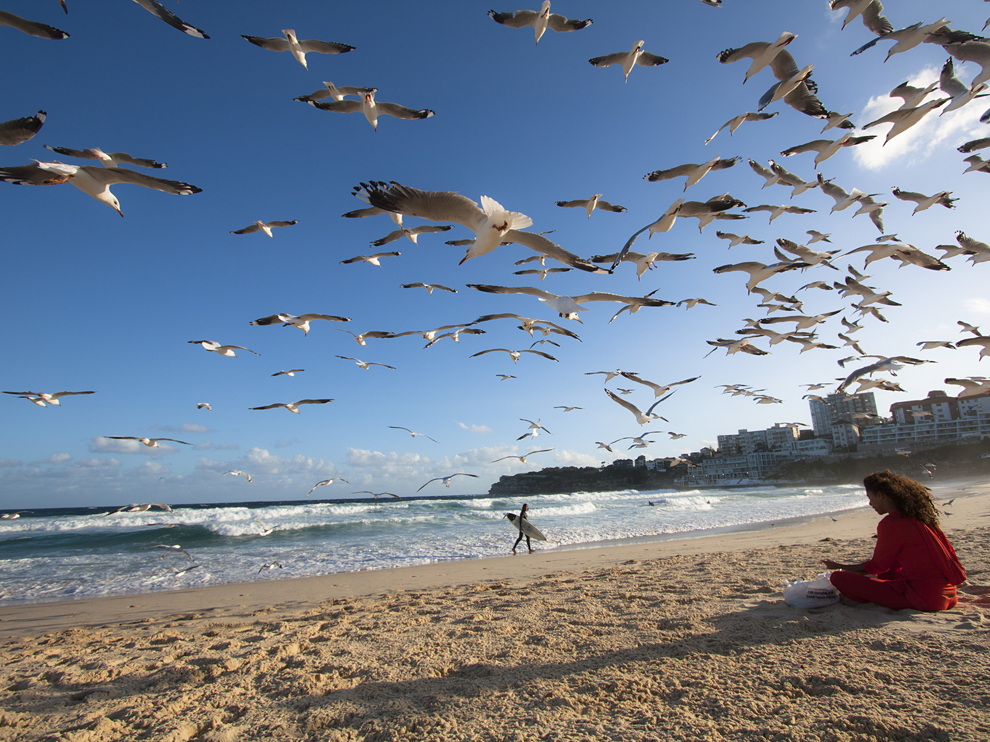 Photo: A woman sitting on Bondi Beach