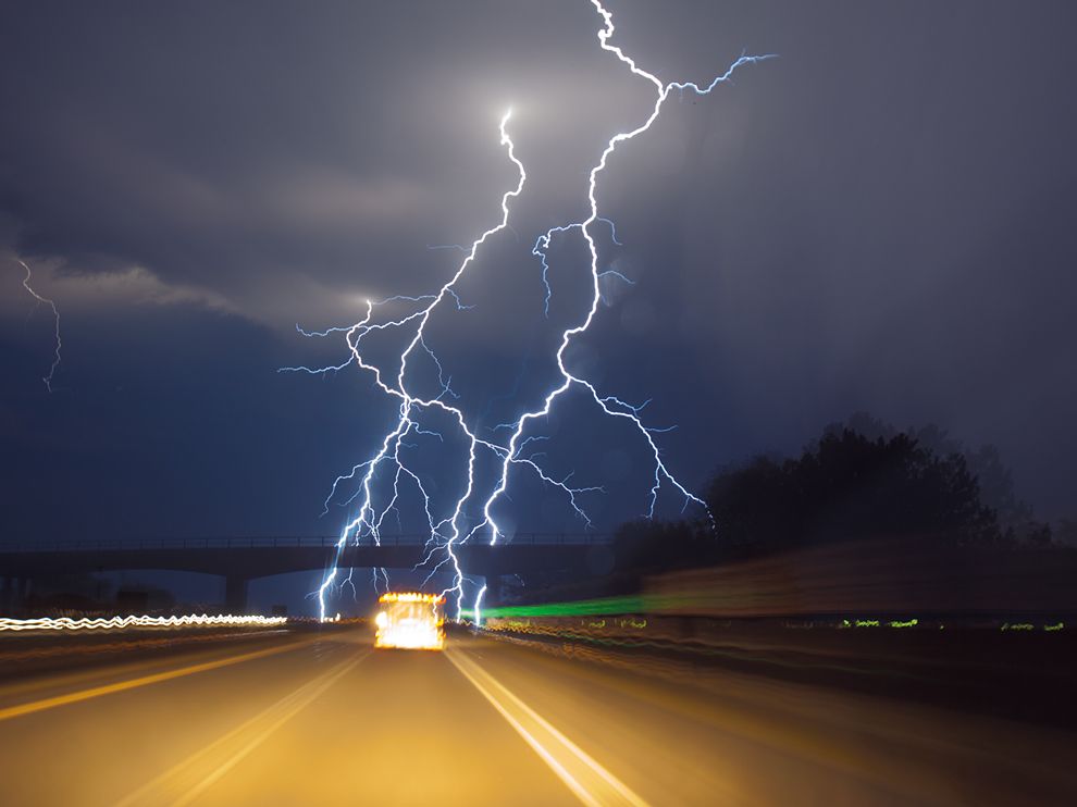 Picture of a storm chaser driving towards lightning